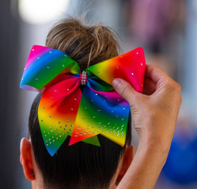 An Aviators fan has her rainbow bow adjusted during Pride Night at the Las Vegas Ballpark on Mo ...