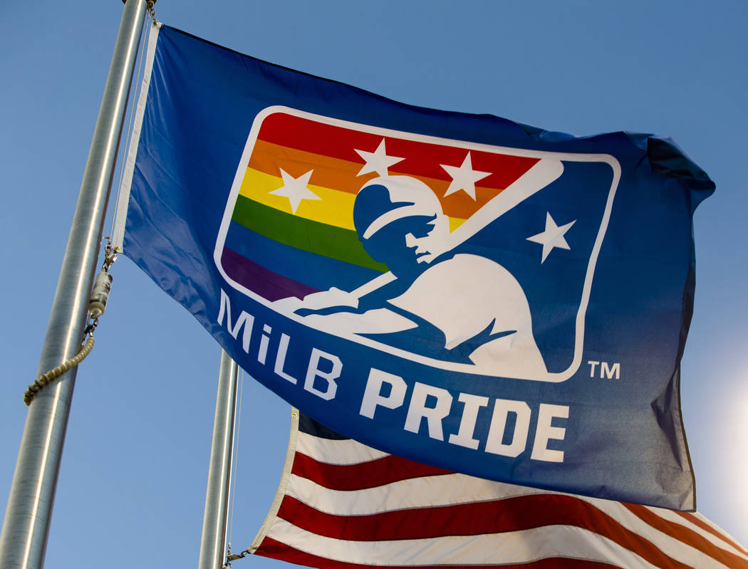 An MiLB Pride flag hangs next to the American flag beyond right field during Pride Night at the ...