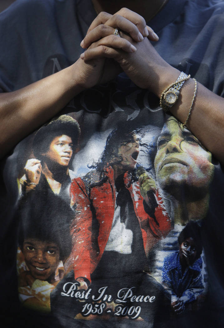 This June 30, 2009 file photo shows a fan wearing a Michael Jackson T-shirt at a makeshift memo ...