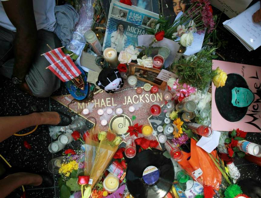 This June 26, 2009 file photo shows a sidewalk shrine of mementos, flowers and candles adorning ...