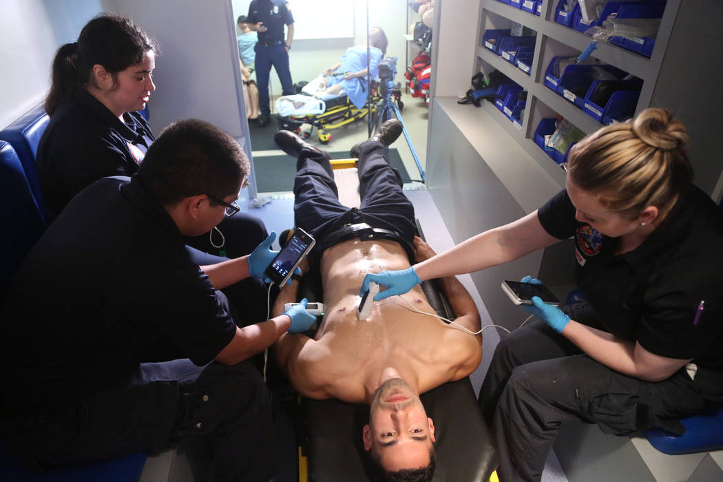 Paramedic student Thomas Vince, center, receives an ultrasound demonstration from fellow parame ...