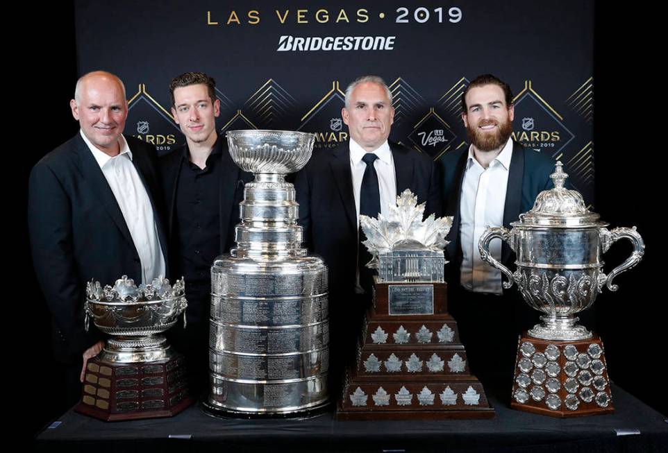 From left, St. Louis Blues general manager Doug Armstrong, goalie Jordan Binnington, interim co ...