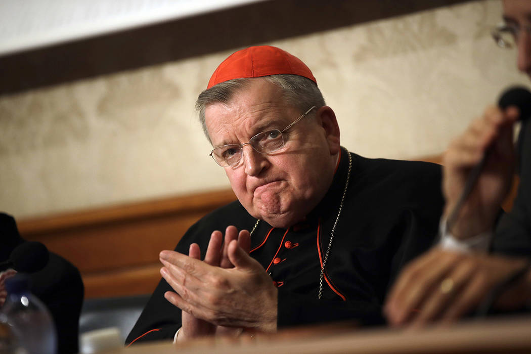 Cardinal Raymond Burke applauds during a press conference on the first anniversary of the death ...