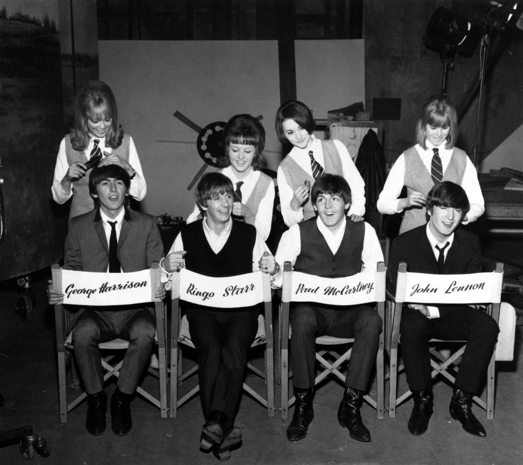 The Beatles, George Harrison, Ringo Starr, Paul McCartney and John Lennon, have their hair comb ...