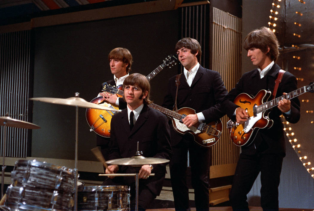 The Beatles pose together before their performance in a TV studio in London, England, in 1966. ...