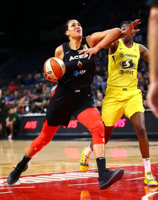 Las Vegas Aces center Liz Cambage, left, drives to the basket against Seattle Storm forward Nat ...