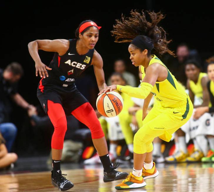 Seattle Storm guard Jordin Canada, right drives the ball under pressure from Las Vegas Aces gua ...