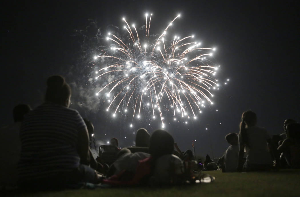 People enjoy the fireworks show at the City of Henderson's Fourth of July celebration at Herita ...