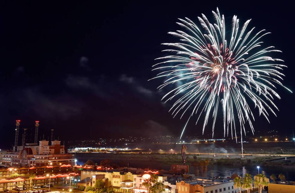 Fireworks illuminate the Colorado River during the 28th annual Rockets Over the River Independe ...