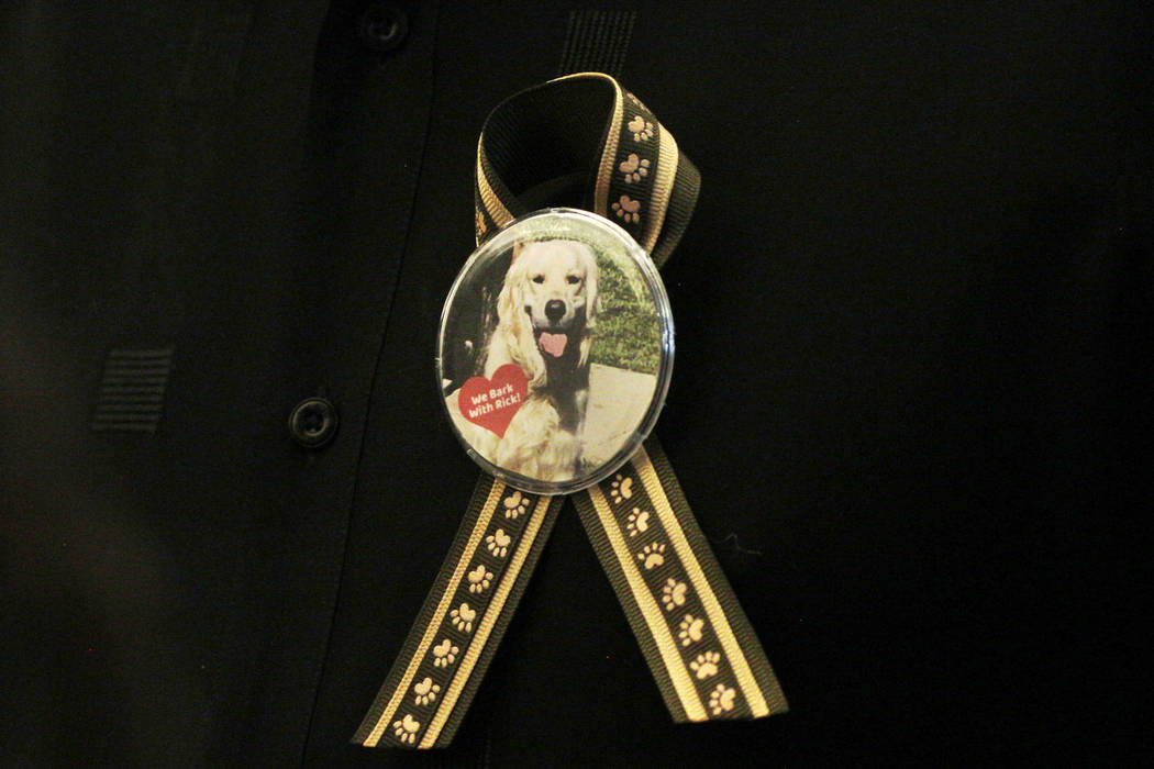 A supporter of dog trainer Ricky Allen Davis wears a button during Davis' hearing at Regional J ...