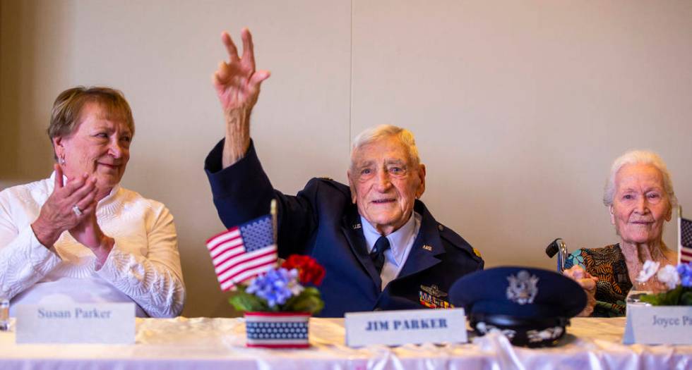 James "Jim" A. Parker waves in recognition beside daughter Susan, left, and wife, Joy ...