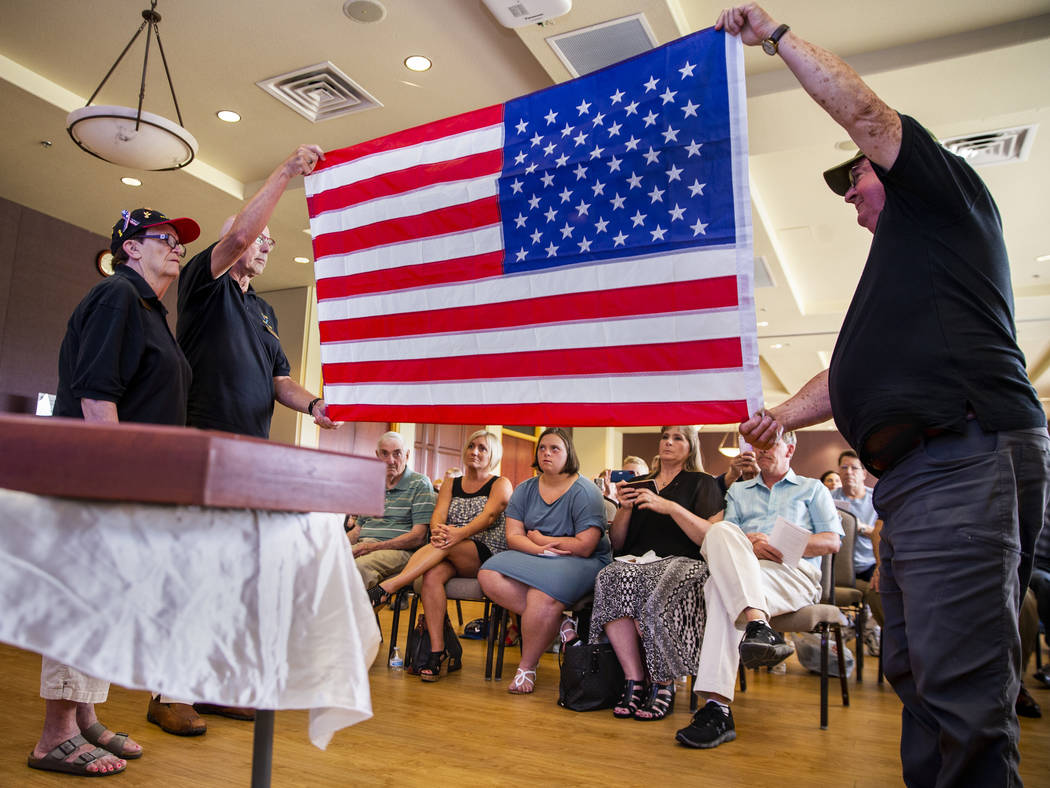 Liz Meyer, Karl Vonderohe and Ken Knudson fold an American flag presented to James "Jim&qu ...