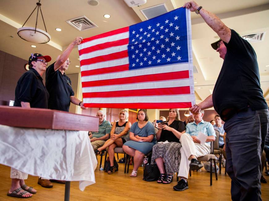 Liz Meyer, Karl Vonderohe and Ken Knudson fold an American flag presented to James "Jim&qu ...