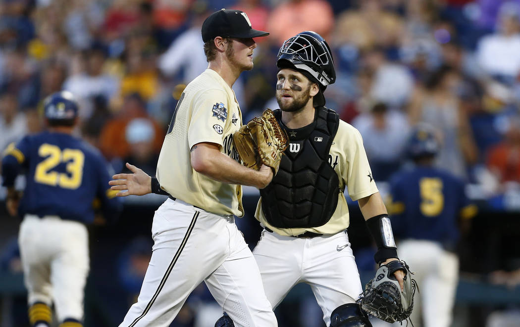 Vanderbilt pitcher Jake Eder, left, is greeted by Philip Clarke during the eighth inning of Gam ...