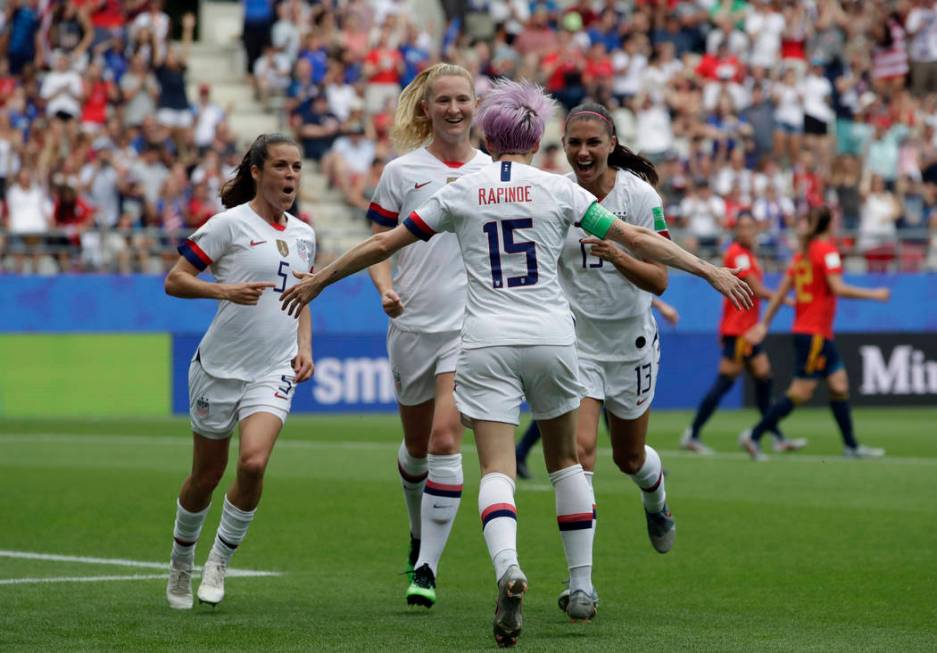United States' Megan Rapinoe, front, celebrates with teammates after scoring the opening goal f ...
