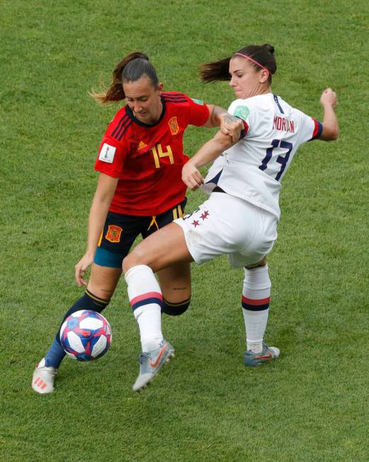 United States' Alex Morgan, right, duels for the ball with Spain's Virginia Torrecilla during t ...