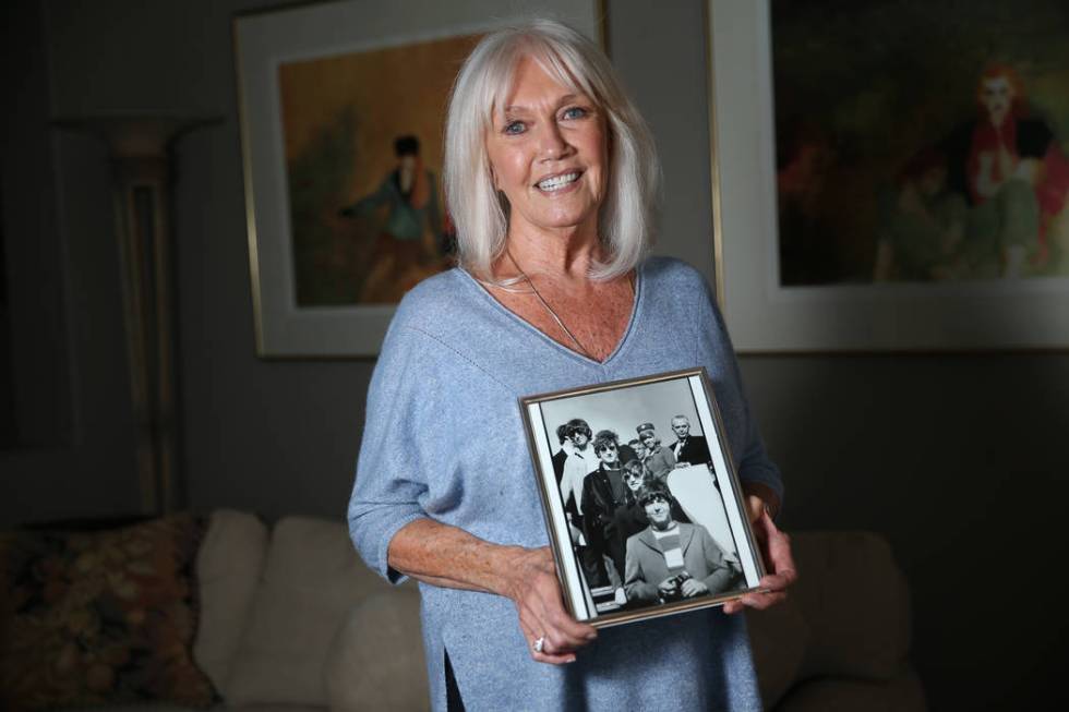 Sonnie Sims, a retired flight attendant, with a picture of herself with the Beatles in 1966, at ...