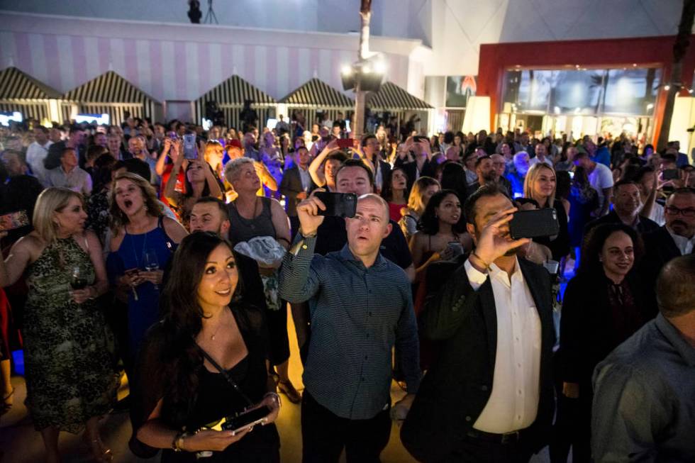 Attendees react to a fireworks show highlighting an event to announce the renaming of SLS Las V ...