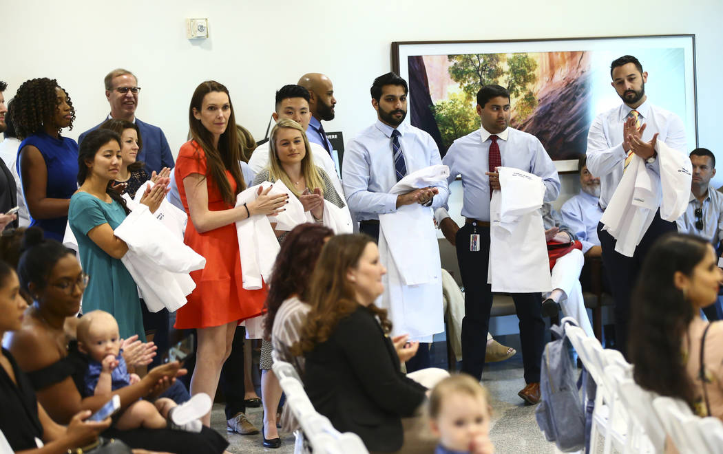 General surgery residents look on while participating in a white coat ceremony for Valley Healt ...