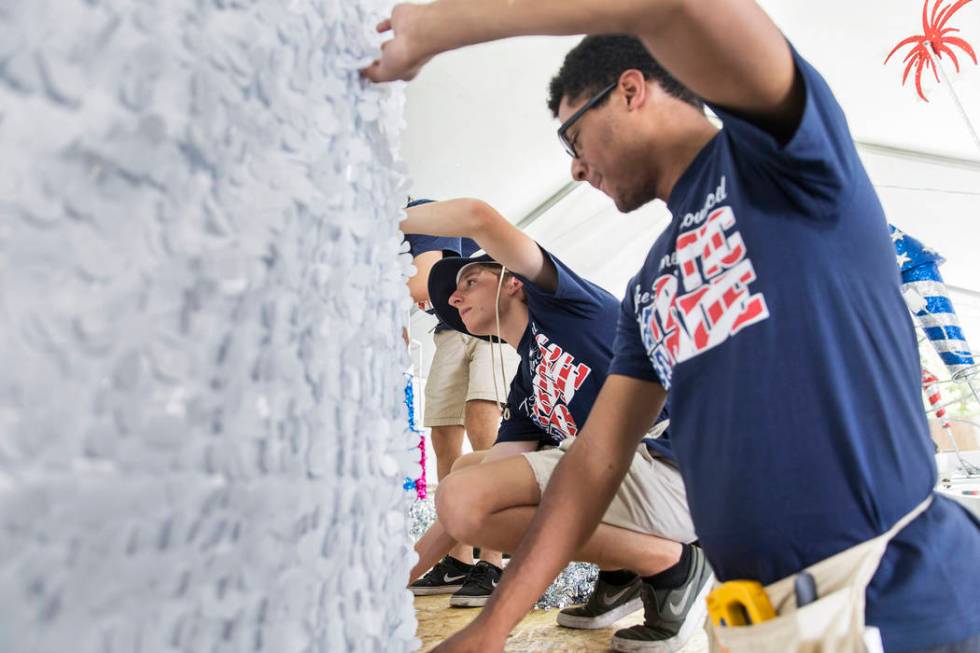 Connor Jordan, center, and Dwight Jones work on a float during preparation for the Summerlin Pa ...