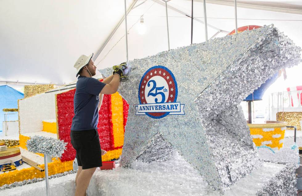 Julien Mihy works on a float during preparation for the Summerlin Patriotic Parade on Saturday, ...