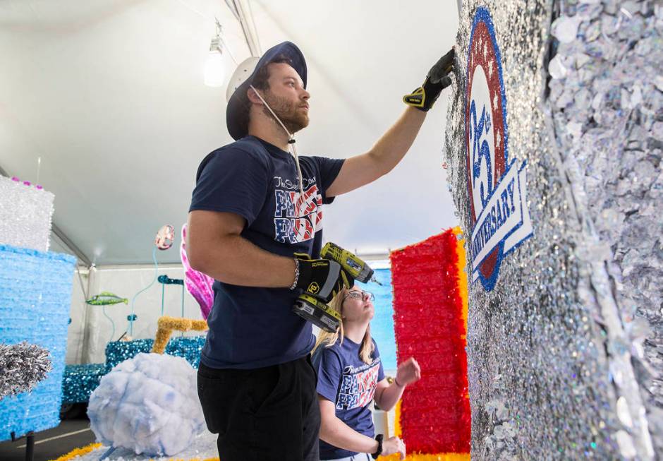 Julien Mihy works on a float during preparation for the Summerlin Patriotic Parade on Saturday, ...