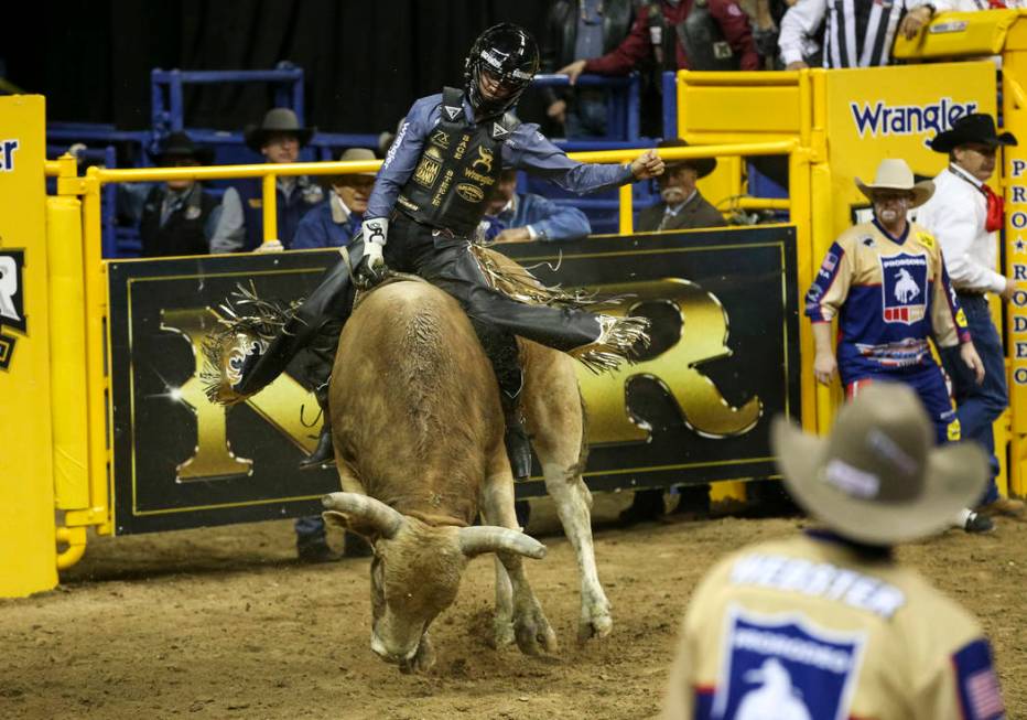 Sage Kimzey of Oklahoma takes part in the bull riding competition during the third go-round of ...