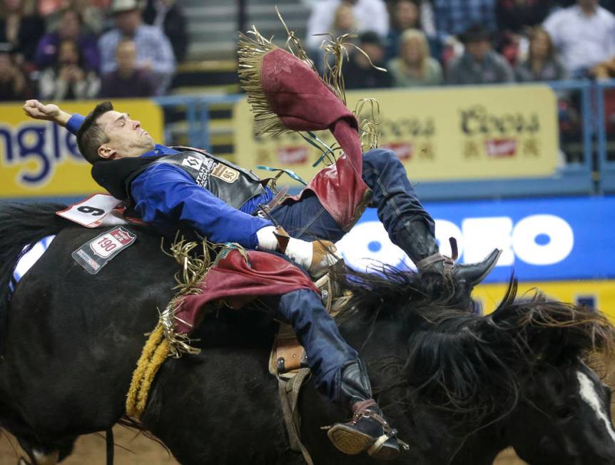 Caleb Bennett of Tremonton, Utah (6) competes in the bareback riding event during the ninth go- ...