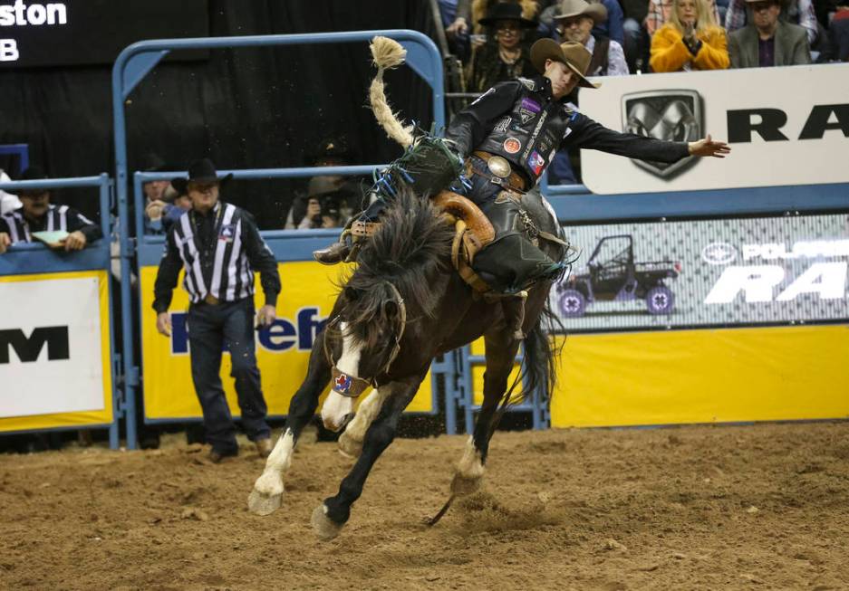 Zeke Thurston of Alberta, Canada (42) competes in the saddle bronc riding event during the nint ...