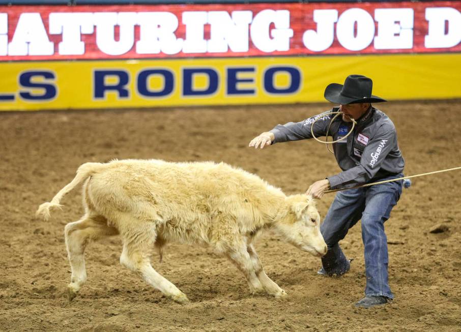 Sterling Smith of Stephenville, Texas (89) competes in the tie-down roping event during the nin ...