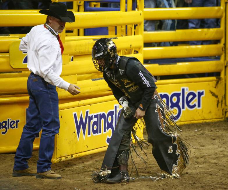 Sage Kimzey of Strong City, Okla. (3)  holds his hand after falling off of "Joker&quo ...