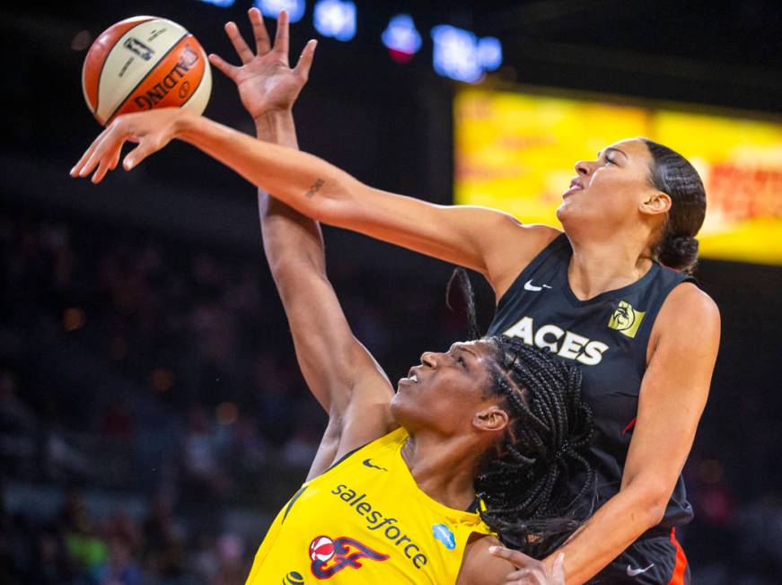 Las Vegas Aces center Liz Cambage, right, deflects a shot by Indiana Fever center Teaira McCowa ...