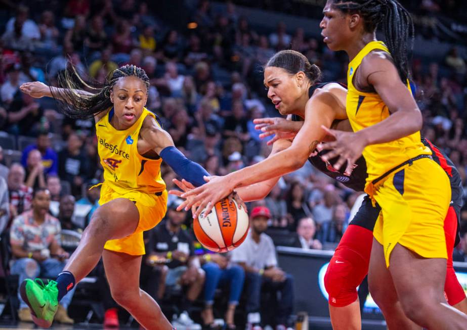 Indiana Fever guard Kelsey Mitchell, left, and Las Vegas Aces center Liz Cambage battle for a l ...