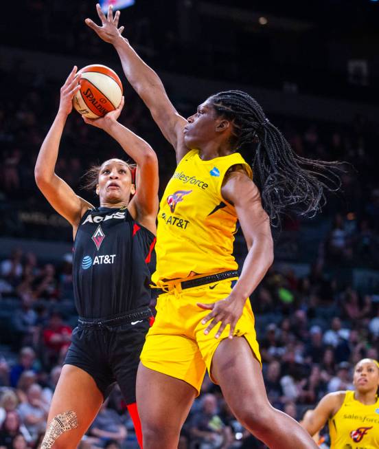 Las Vegas Aces center A'ja Wilson (22) gets off a shot over Indiana Fever center Teaira McCowan ...