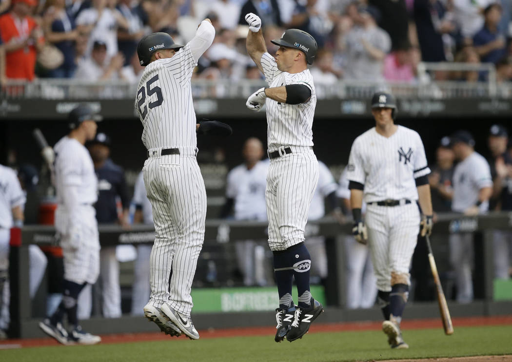 New York Yankees' Brett Gardner, right, celebrates after hitting a two-run home run with Gleybe ...