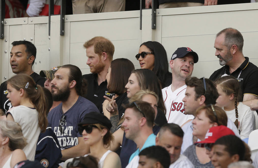 Britain's Prince Harry, top center left, and Meghan, Duchess of Sussex, watch during the first ...