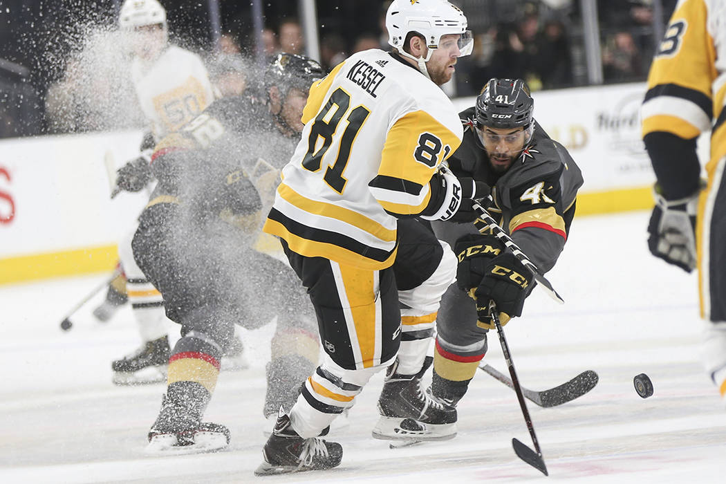 Golden Knights center Pierre-Edouard Bellemare (41) sends the puck past Pittsburgh Penguins rig ...