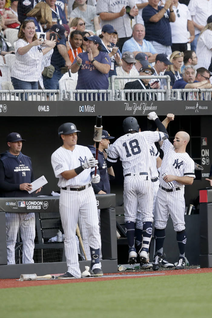 New York Yankees' Didi Gregorius (18) celebrates at the dugout after a home run against the Bos ...