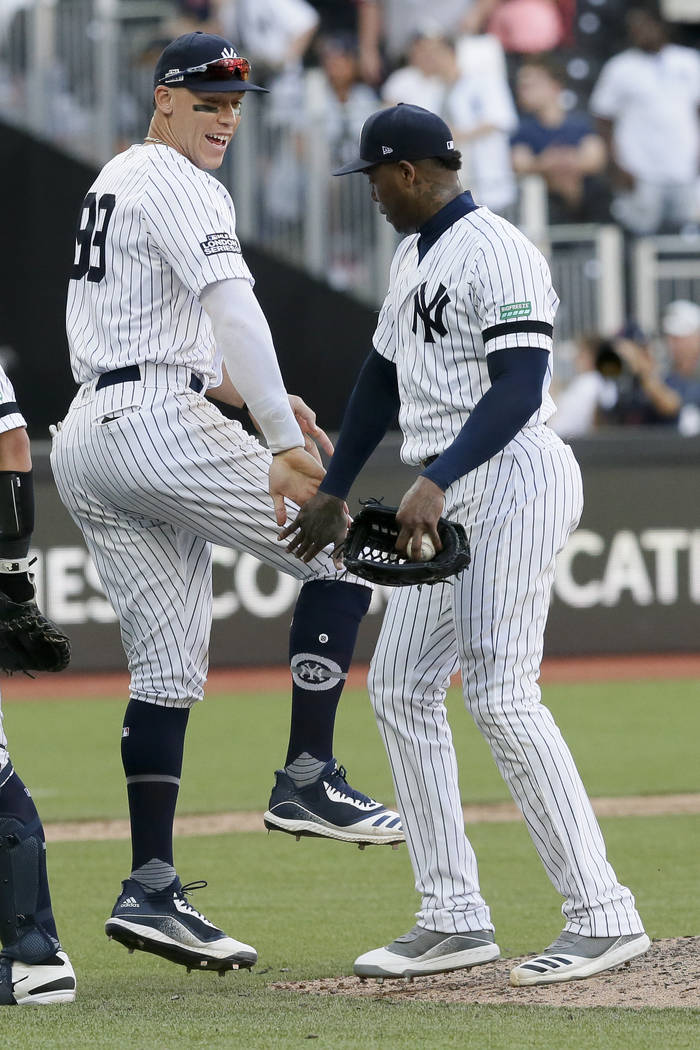 New York Yankees right fielder Aaron Judge, left, and relief pitcher Aroldis Chapman celebrate ...