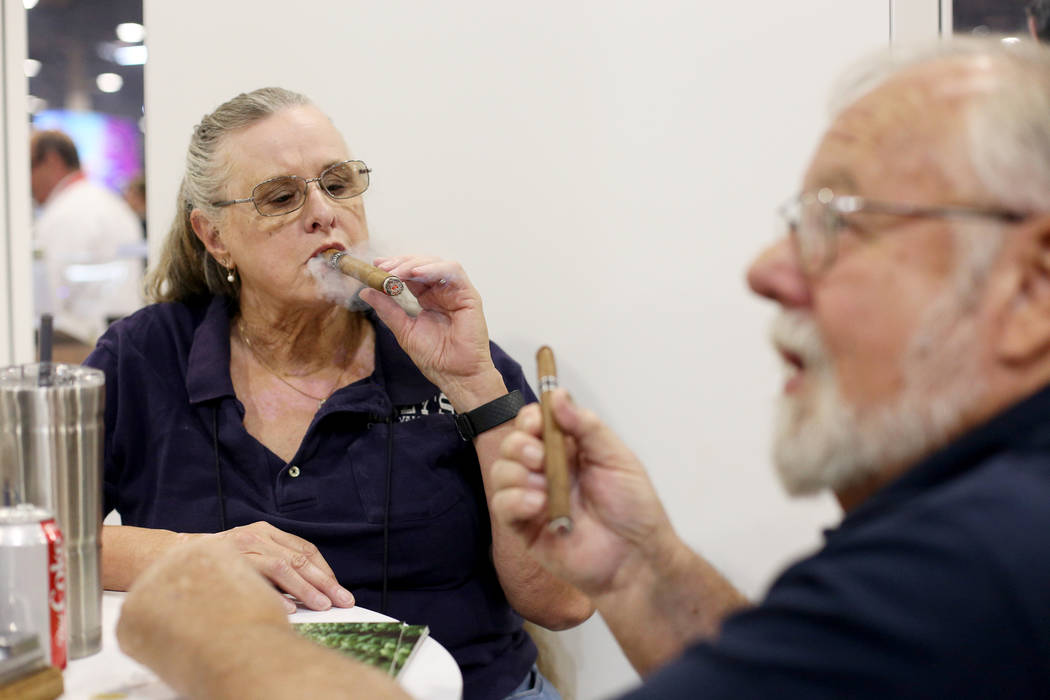 Jan and her husband Dave Mazy try out cigars at the International Premium Cigar & Pipe Reta ...