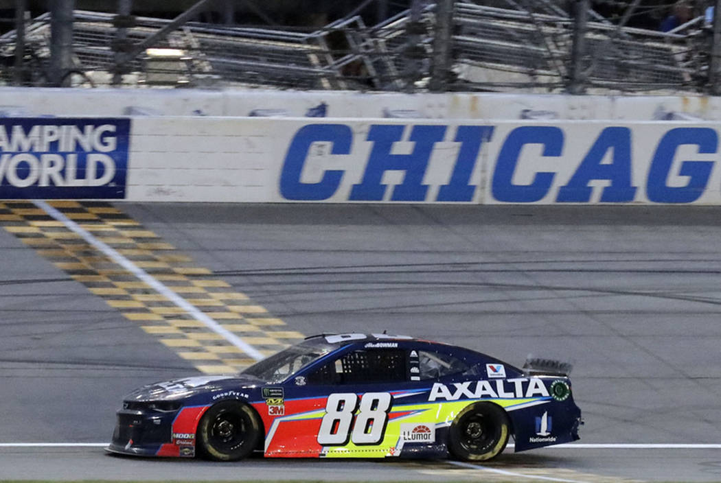 Alex Bowman crosses the finish line to win the NASCAR Cup Series auto race at Chicagoland Speed ...