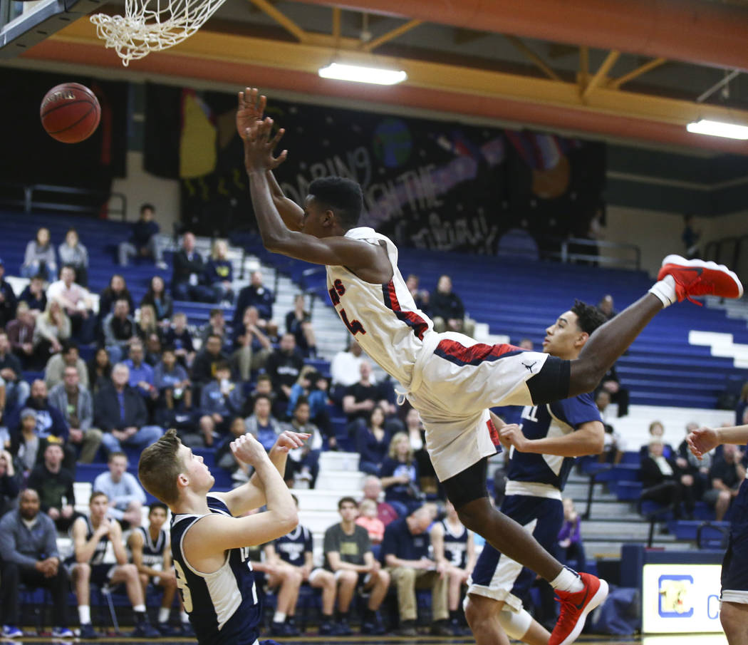 Coronado’s Taieem Comeaux (44) gets tripped up during a basketball game at Coronado Hi ...