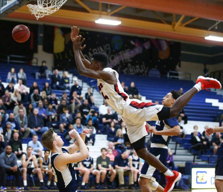 Coronado’s Taieem Comeaux (44) gets tripped up during a basketball game at Coronado Hi ...