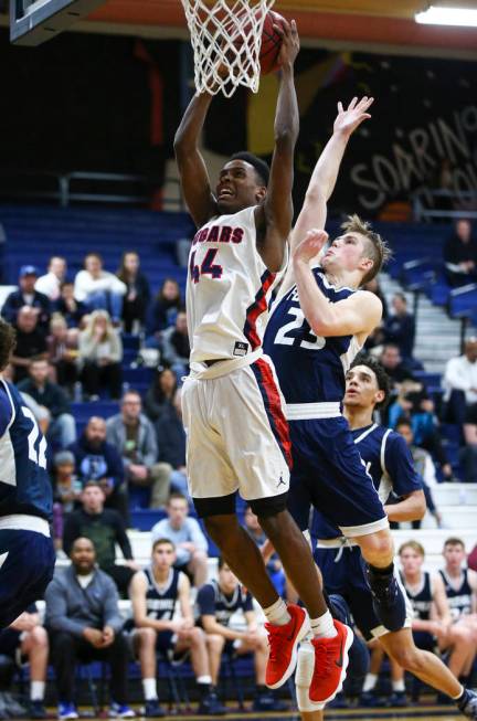 Coronado’s Taieem Comeaux (44) goes to the basket past Foothill’s Mike Shaw (23) ...