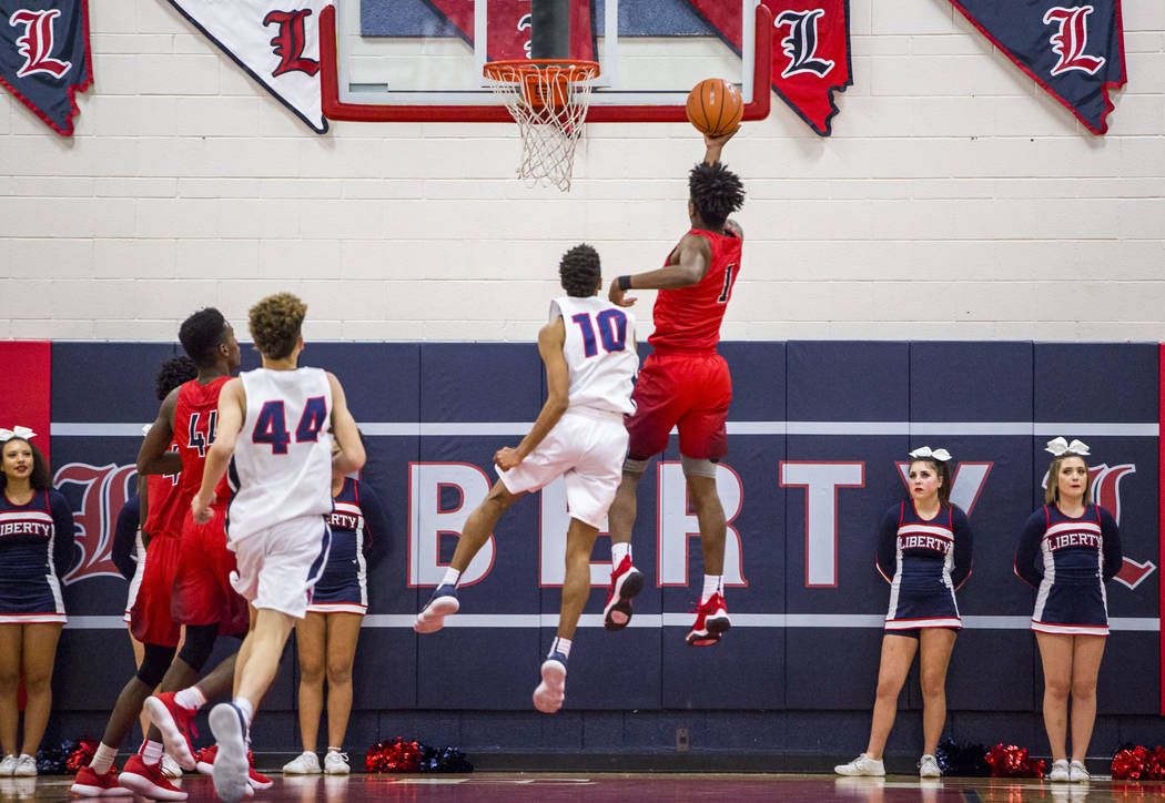 Coronado’s Jaden Hardy (1) lays up while Liberty’s Jordan Holt tries to block hi ...