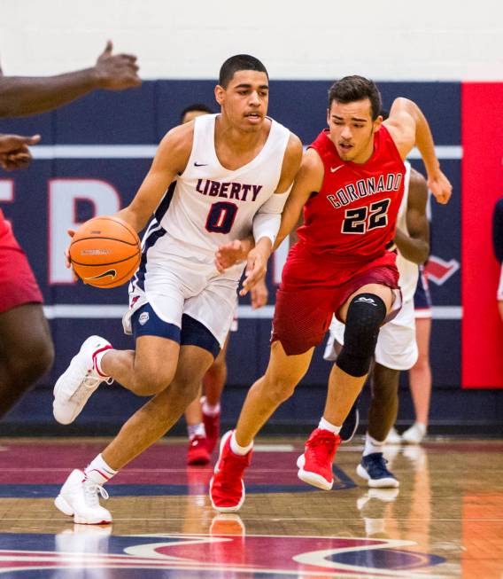 Liberty’s Julian Strawther (0) dribbles around Coronado’s Patrick Simms (22) at ...