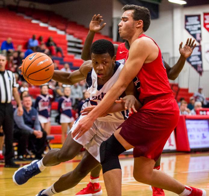 Liberty’s Jordan Wafer (22) tries to dribble around Coronado’s Patrick Simms (22 ...