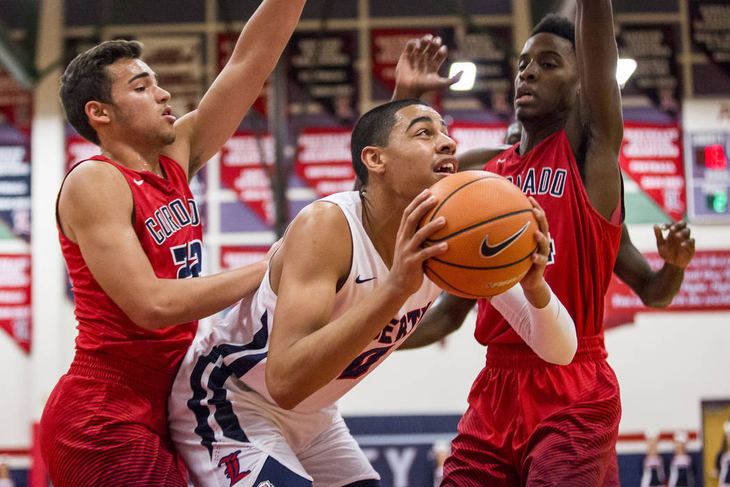 Liberty’s Julian Strawther (0) looks for a shot while Coronado’s Patrick Simms ( ...