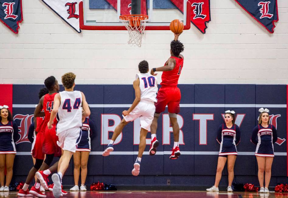 Coronado’s Jaden Hardy (1) lays up while Liberty’s Jordan Holt tries to block hi ...