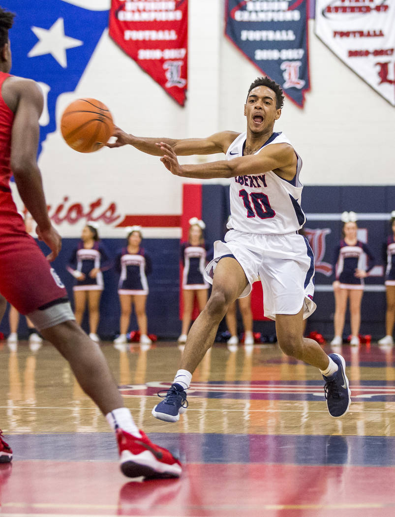 Liberty’s Tyrelle Hunt (10) dribbles down the court while Coronado’s Jaden Hardy ...